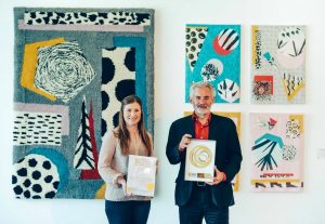 Hannah Harris, Director of Development, and Professor Andrew Brewerton, Principal and Chief Executive of Plymouth College of Art, with the Social Enterprise Gold Mark award