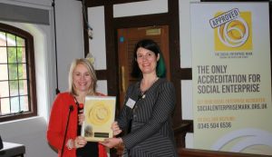 Professor Joy Carter of University of Winchester receiving Social Enterprise Gold Mark from Lucy Findlay