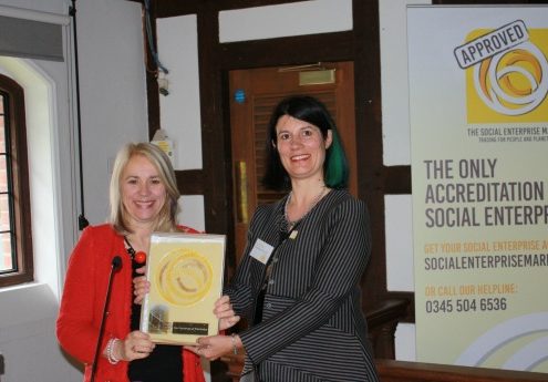 Professor Joy Carter of University of Winchester receiving Social Enterprise Gold Mark from Lucy Findlay