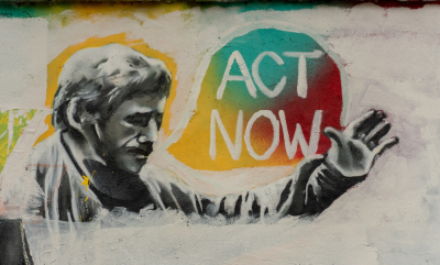 Mural of man saying 'Act Now'