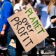 Person holding sign saying 'Planet over Profit'