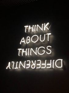 Neon sign saying ' think about things differently'