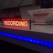 Neon sign in a recording studio that says 'Recording'