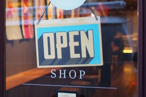 Photo of a shopfront with an open sign in the window