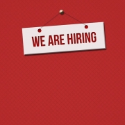 Red background with a white sign saying 'We are hiring'