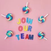 Pink background with colourful letters spelling out 'join our team'