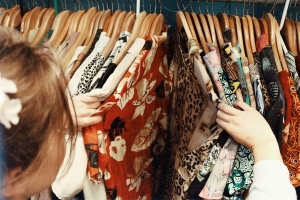 Photo of a woman looking at clothes on a clothes rail