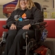 Photo of a woman in a wheelchair wearing a black jumper